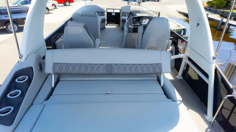 Slide: The Image of 2022 Bennington 24 LXSBA pontoon boat interior with seating and cup holders. - 10