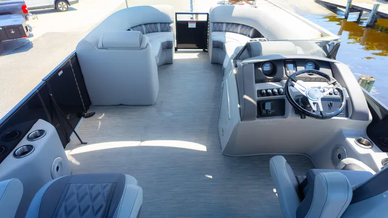 Slide: The Image of 2022 Bennington 24 LXSBA pontoon boat interior with modern helm and spacious seating. - 11