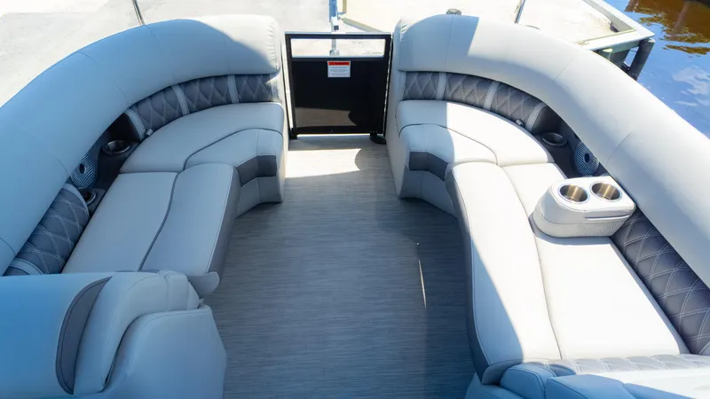 Slide: The Image of Luxurious seating on 2022 Bennington 24 LXSBA pontoon boat with cup holders and elegant design. - 12