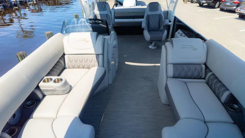 Slide: The Image of 2022 Bennington 24 LXSBA pontoon boat interior with luxurious seating and cup holders. - 13