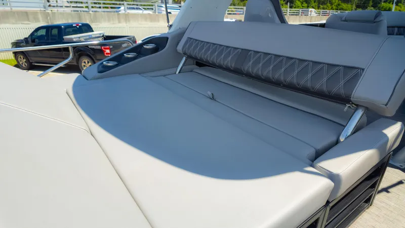 Slide: The Image of 2022 Bennington 24 LXSBA boat with luxurious seating and cup holders. - 18
