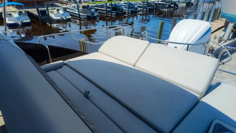 Slide: The Image of 2022 Bennington 24 LXSBA boat with luxurious seating at a marina. - 19