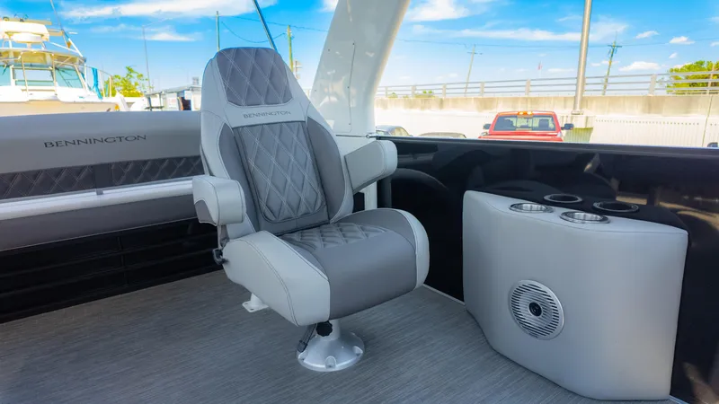 Slide: The Image of 2022 Bennington 24 LXSBA boat interior with luxury seating and cup holders. - 20