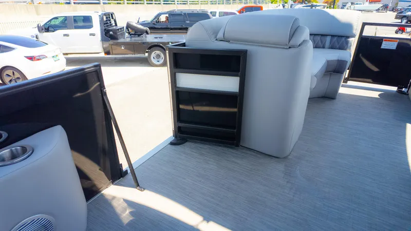 Slide: The Image of 2022 Bennington 24 LXSBA pontoon boat interior with gray seating and storage compartments. - 21