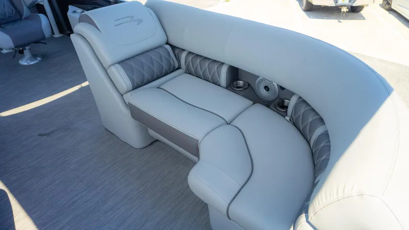 Slide: The Image of 2022 Bennington 24 LXSBA boat interior with luxurious gray seating and cup holders. - 22