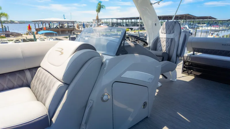 Slide: The Image of 2022 Bennington 24 LXSBA boat interior with luxurious seating and modern helm. - 26