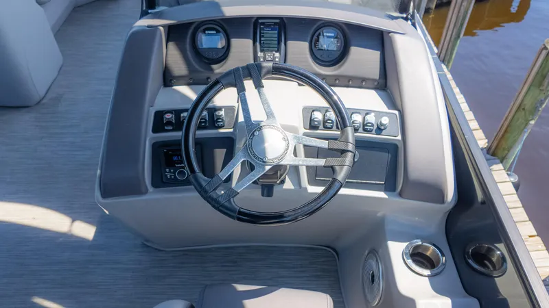 Slide: The Image of 2022 Bennington 24 LXSBA boat dashboard with steering wheel and controls. - 29