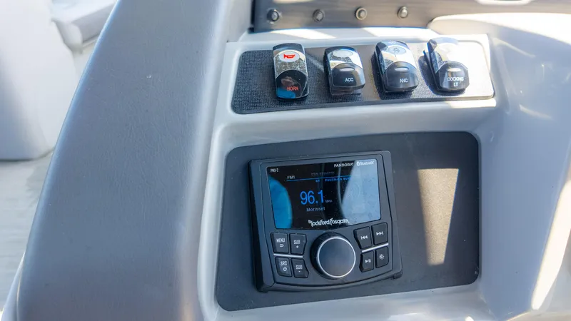 Slide: The Image of Control panel of 2022 Bennington 24 LXSBA boat with radio and switches. - 30
