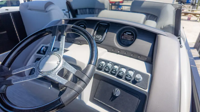 Slide: The Image of 2022 Bennington 24 LXSBA boat dashboard with steering wheel and control panel. - 32