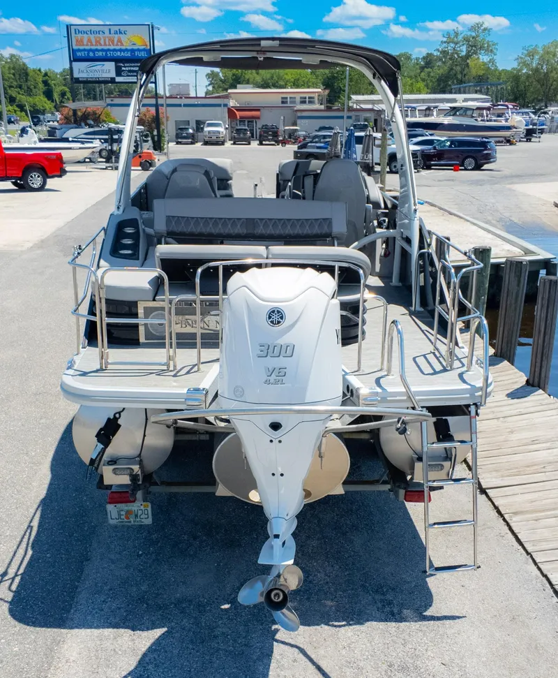 Slide: The Image of 2022 Bennington 24 LXSBA pontoon boat with Yamaha 300 V6 engine at marina dock. - 7