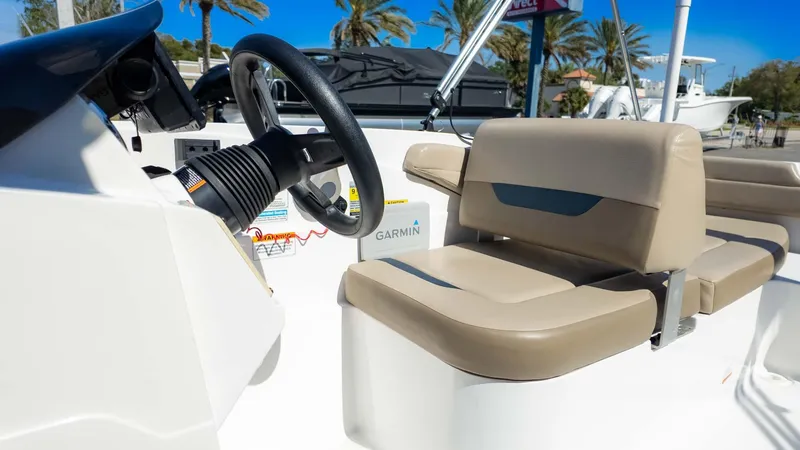 Slide: The Image of Interior of 2022 Hurricane SS185 boat with beige seating and steering wheel. - 15
