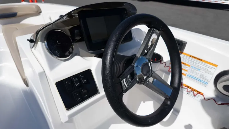 Slide: The Image of 2022 Hurricane SS185 boat dashboard with steering wheel and control panel. - 16