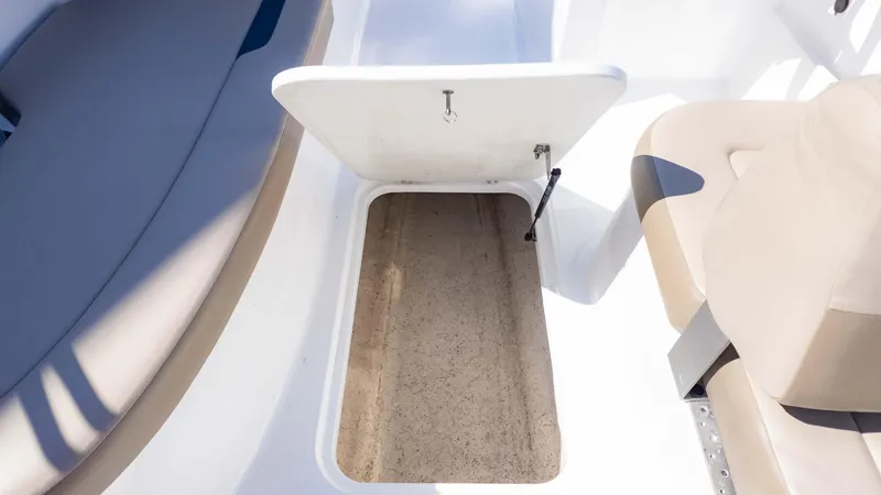 Slide: The Image of Open storage compartment on 2022 Hurricane SS185 boat, featuring beige seating. - 8
