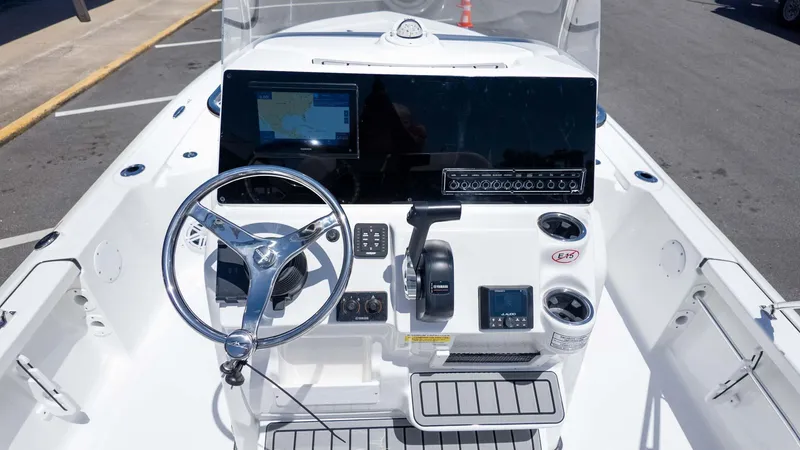 Slide: The Image of 2025 Tidewater 2110 Bay Max boat dashboard with steering wheel and navigation controls. - 11