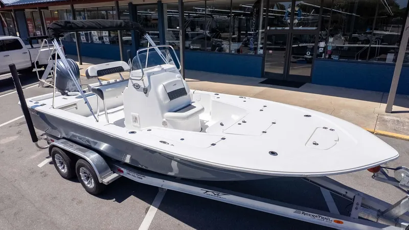 Slide: The Image of 2025 Tidewater 2110 Bay Max boat on trailer, parked outside a dealership. - 4