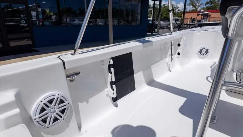 Slide: The Image of 2025 Tidewater 2110 Bay Max boat interior with speakers and rod holders. - 8