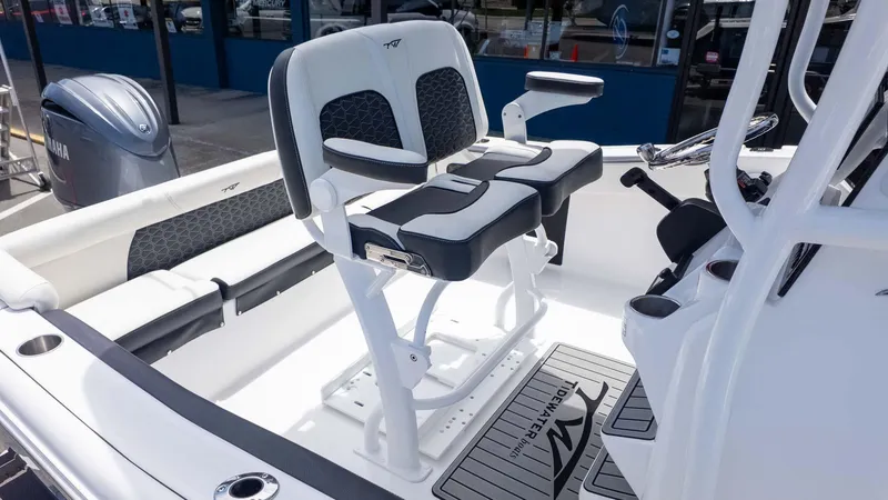 Slide: The Image of 2025 Tidewater 220LXF boat interior with dual seats and Yamaha engine. - 11