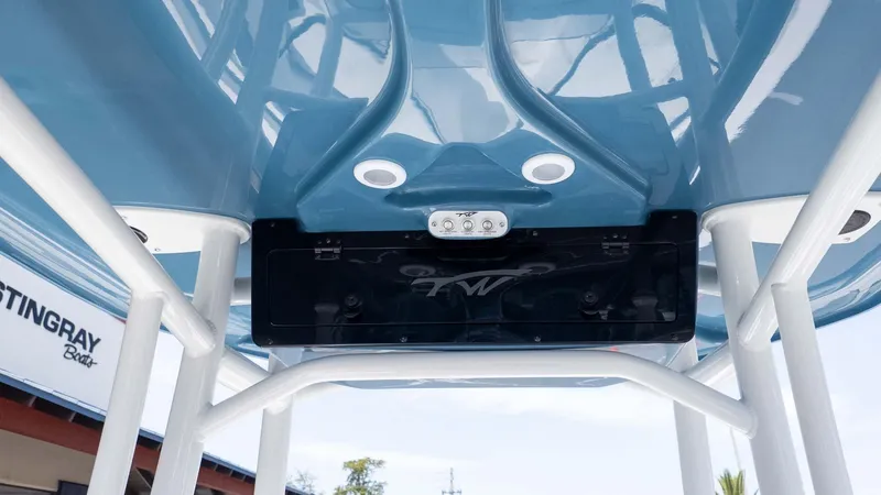 Slide: The Image of 2025 Tidewater 220LXF boat's blue T-top with integrated lighting and speaker system. - 14