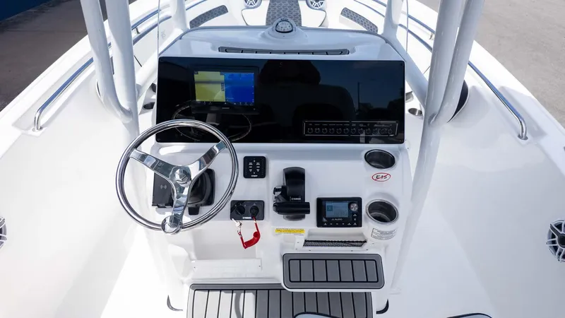 Slide: The Image of 2025 Tidewater 220LXF boat console with steering wheel, digital display, and controls. - 15