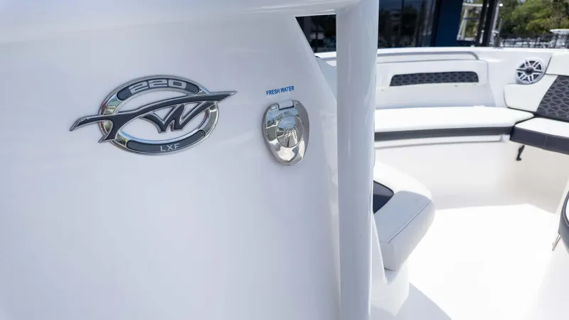 Slide: The Image of 2025 Tidewater 220LXF boat interior with logo and seating area. - 18