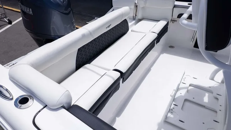Slide: The Image of 2025 Tidewater 220LXF boat interior with white cushioned seating and Yamaha engine. - 5