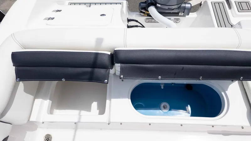 Slide: The Image of 2025 Tidewater 220LXF boat interior with seating and storage compartment. - 6