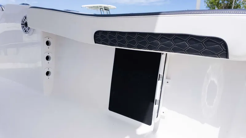 Slide: The Image of 2025 Tidewater 220LXF boat interior detail with speaker and storage compartment. - 8