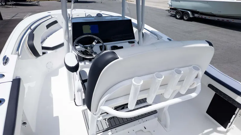 Slide: The Image of 2025 Tidewater 220LXF boat interior with steering wheel and rod holders. - 9