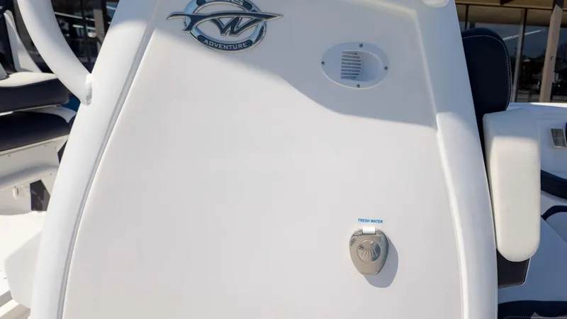 Slide: The Image of 2025 Tidewater 256CC boat console with Adventure logo and fresh water access. - 17