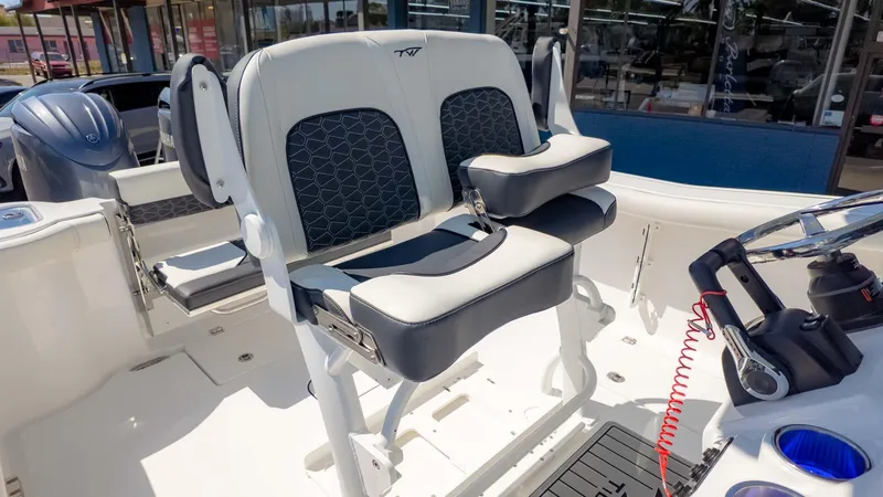 Slide: The Image of 2025 Tidewater 256CC boat interior with dual helm seats and modern controls. - 18