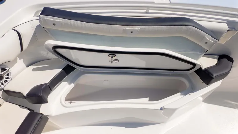 Slide: The Image of 2025 Tidewater 256CC boat storage compartment with cushioned seating and sleek design. - 20