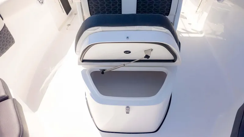 Slide: The Image of 2025 Tidewater 256CC boat seat with open storage compartment. - 22