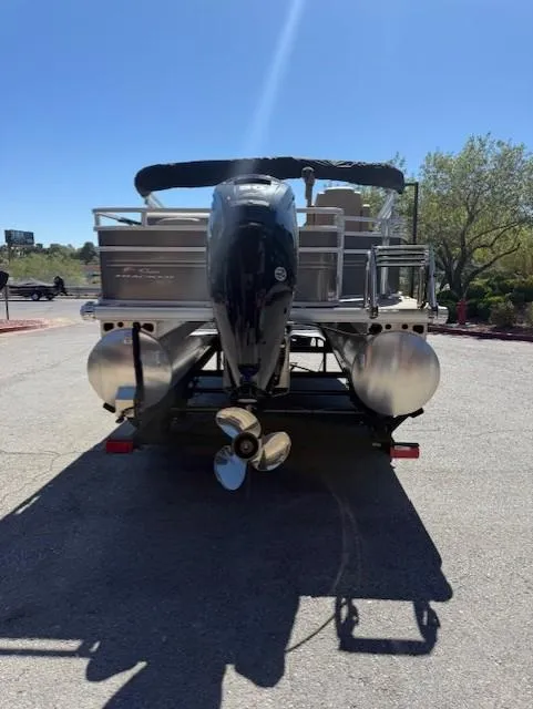 Slide: The Image of 2025 Sun Tracker Fishin' Barge 20 DLX pontoon boat, rear view with outboard motor. - 4