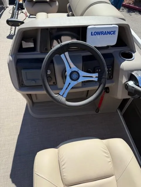 Slide: The Image of 2025 Sun Tracker Fishin' Barge 20 DLX dashboard with steering wheel and Lowrance device. - 5