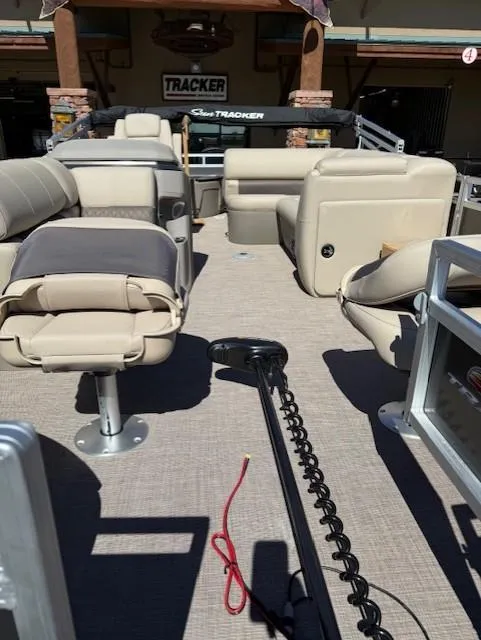 Slide: The Image of 2025 Sun Tracker Fishin' Barge 20 DLX interior with seating and fishing equipment. - 7