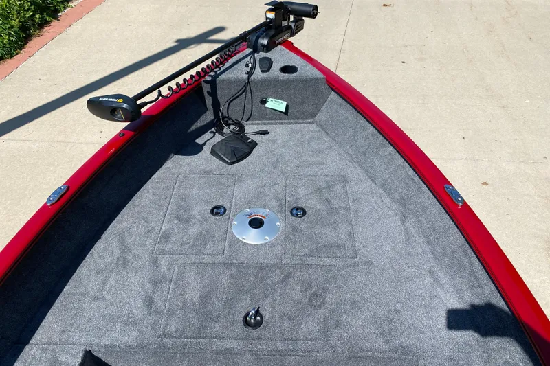 Slide: The Image of 2025 Tracker Super Guide V-16 T boat deck with trolling motor, red trim, and gray carpet. - 3