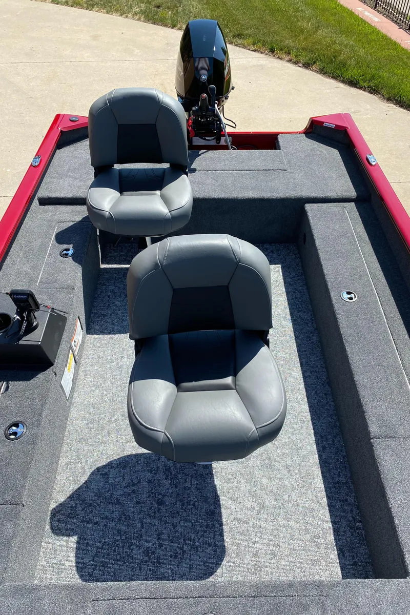 Slide: The Image of 2025 Tracker Super Guide V-16 T boat with dual seats and motor, parked on concrete. - 4