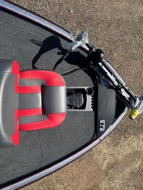 Slide: The Image of 2025 Nitro Z19 boat interior with red and gray seating, steering controls, and carpeted flooring. - 10