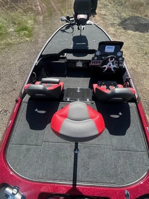 Slide: The Image of 2025 Nitro Z19 boat interior with red and gray seating, steering console, and carpeted deck. - 11