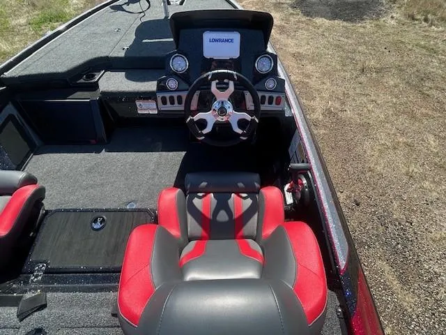 Slide: The Image of 2025 Nitro Z19 boat interior with red and gray seating, steering wheel, and dashboard display. - 12