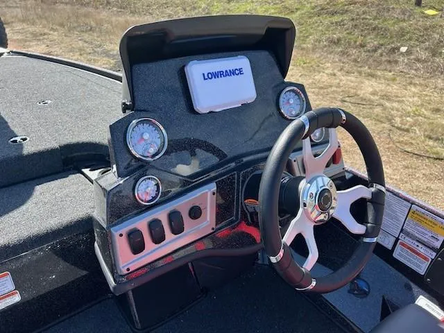 Slide: The Image of 2025 Nitro Z19 boat dashboard with steering wheel, gauges, and Lowrance display. - 15