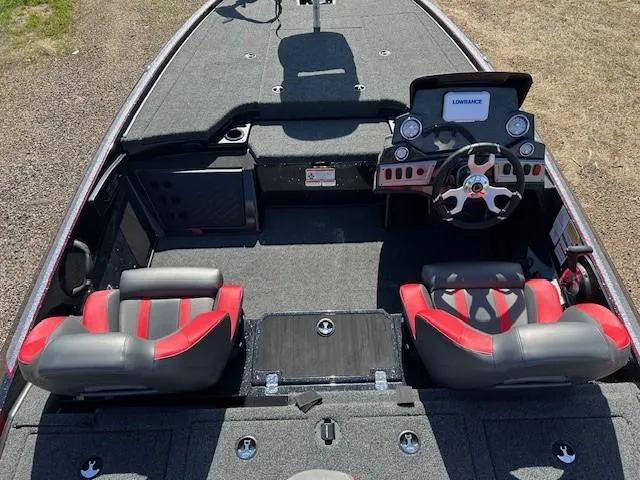 Slide: The Image of 2025 Nitro Z19 boat interior with red and gray seats, steering wheel, and dashboard. - 16