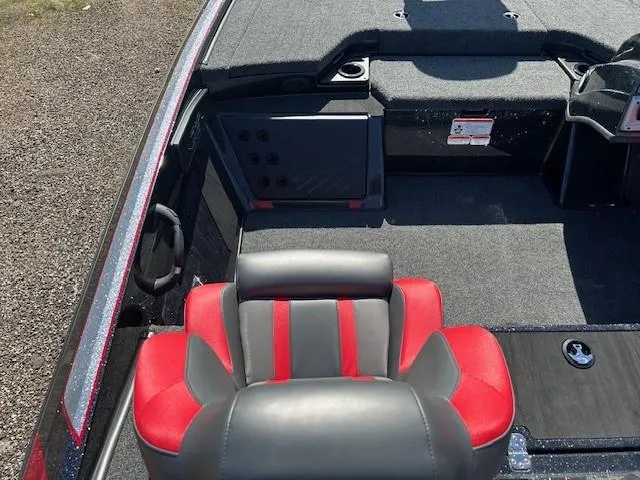 Slide: The Image of 2025 Nitro Z19 boat interior with red and gray seating, carpeted deck, and storage compartments. - 17