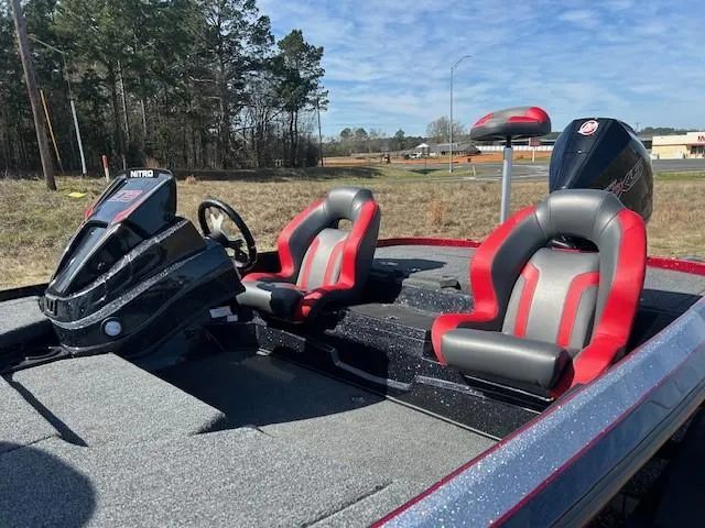 Slide: The Image of 2025 Nitro Z19 boat with red and gray seats, steering console, and outboard motor. - 3