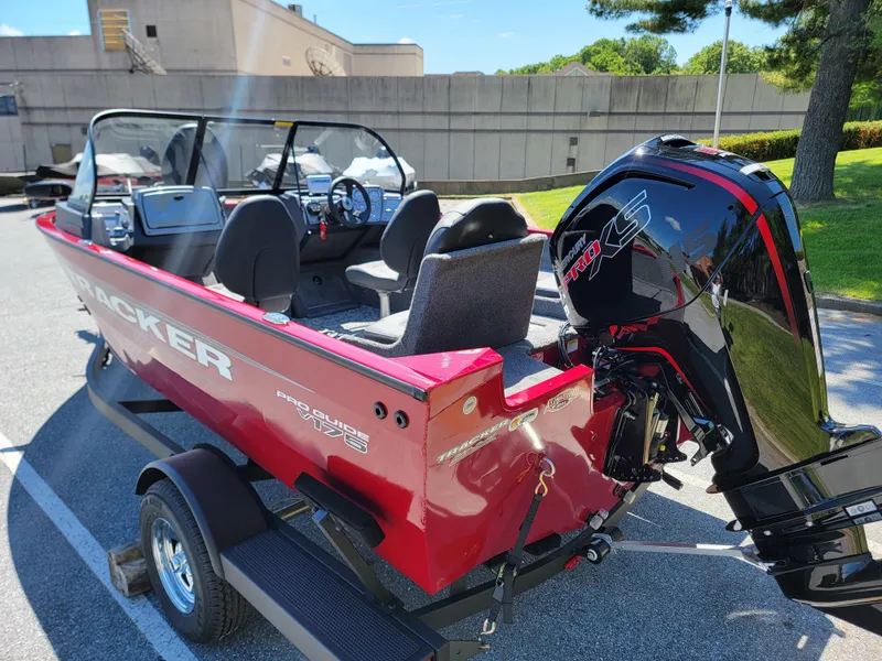 Slide: The Image of 2025 Tracker Pro Guide V-175 Combo boat with powerful outboard motor, parked on a trailer. - 2