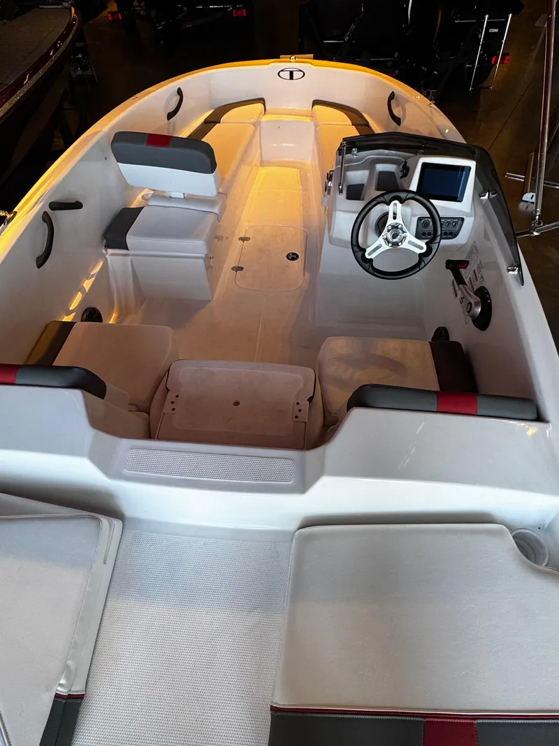 Slide: The Image of 2025 Tahoe T16 boat interior with steering wheel and seating arrangement. - 2