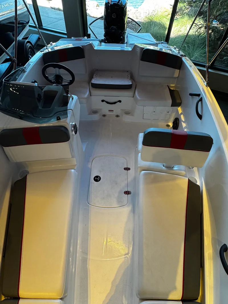 Slide: The Image of 2025 Tahoe T16 boat interior with seating and steering wheel, showcasing modern design and functionality. - 3