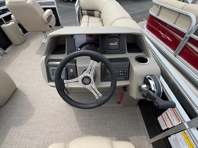 Slide: The Image of 2025 Sun Tracker SportFish 20 DLX boat dashboard with steering wheel and controls. - 4