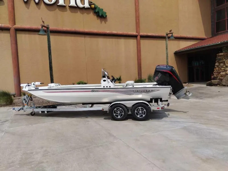 The Image of 2025 Ranger RB210 boat on trailer outside a building, showcasing sleek design and powerful engine. - 0