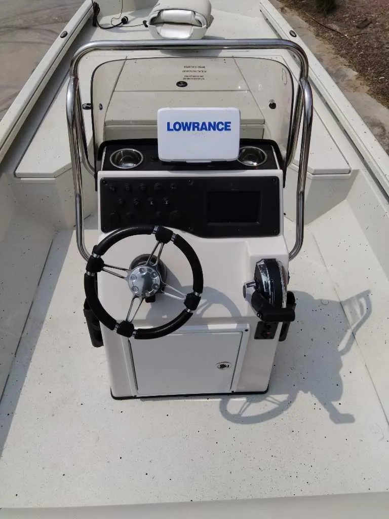 Slide: The Image of 2025 Ranger RB210 boat console with steering wheel and Lowrance navigation system. - 2